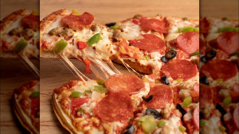 Tombstone pizza slice being pulled