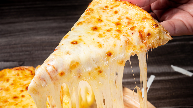 A slice of pizza with loads of cheese.