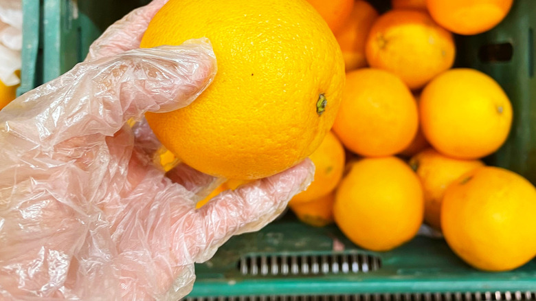 An orange undergoing inspection.