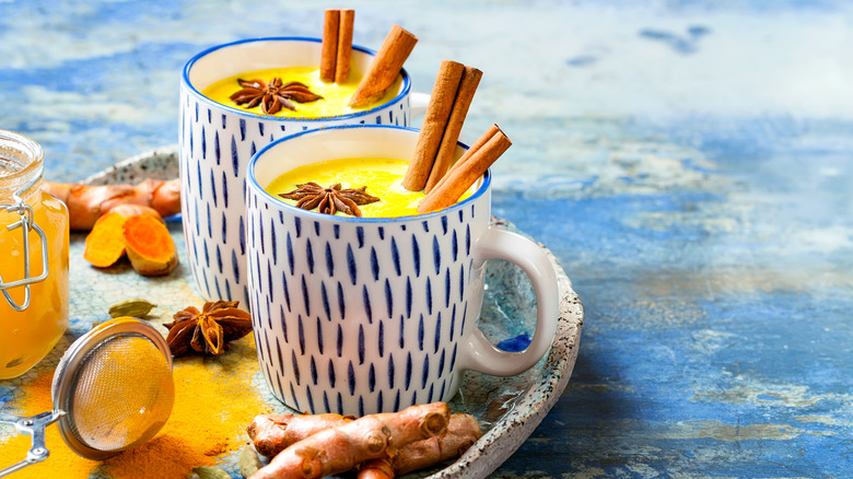 Mugs of turmeric golden milk