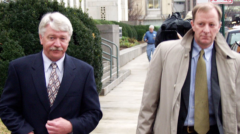 Tyson executive Robert Hash (L) and his lawyer leave the Federal Court Building in Chattanooga, TN, in 2002 after pleading not guilty to charges that he broke various immigration laws.