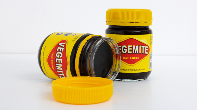 two jars of vegemite, on on its side