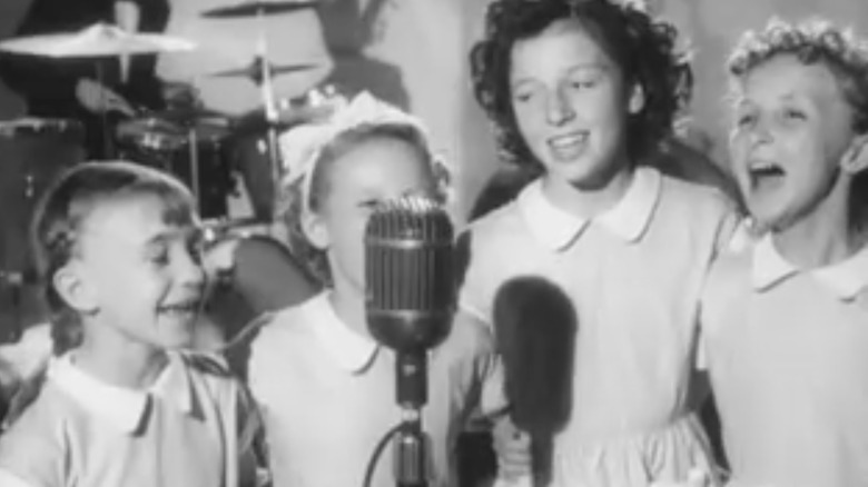 four happy girls singing