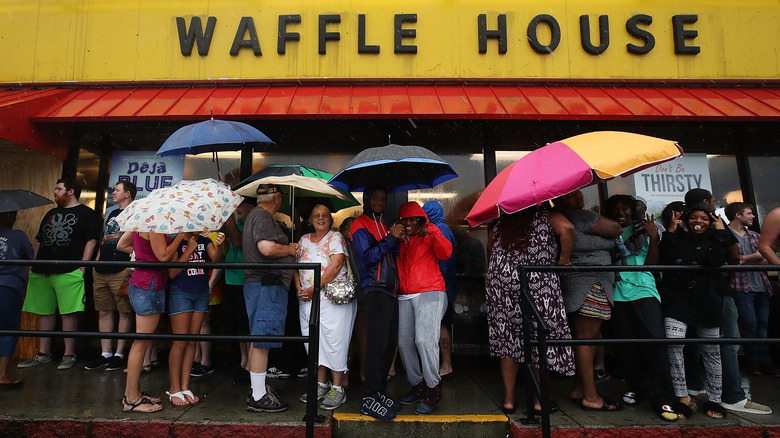 crowd with umbrellas at waffle house