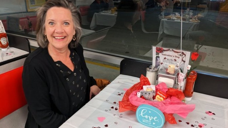 lady and decorated table at Waffle House on Valentine's Day