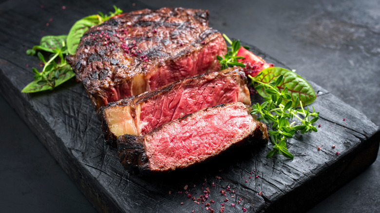 Cooked steak cut into thick slices and garnished. 