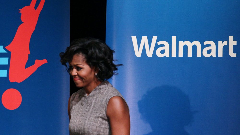 Michelle Obama walks on stage at a walmart event