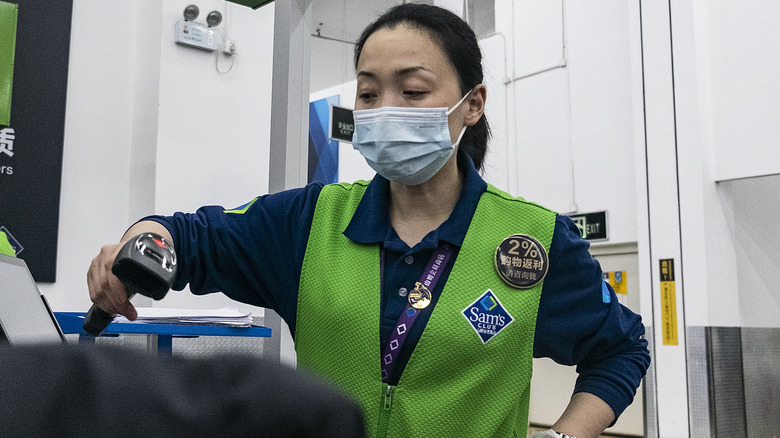 Walmart employee in green vest