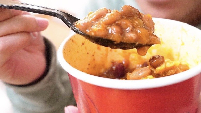 Spoon holding bite of Wendy's chili