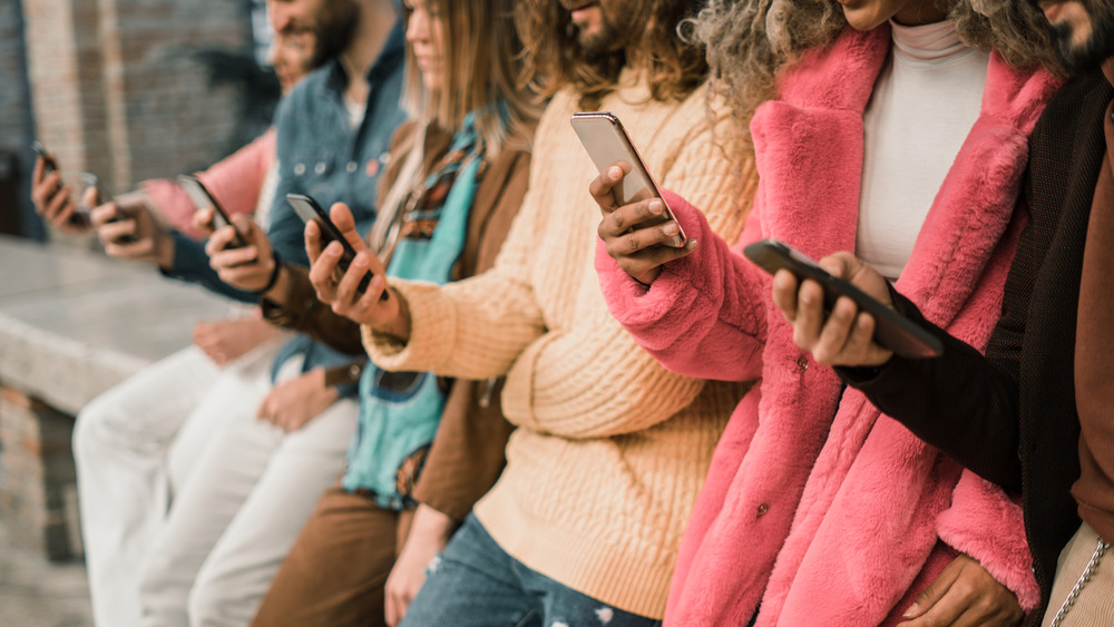 Group of people using their phones