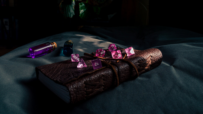 Game dice on bound leather book