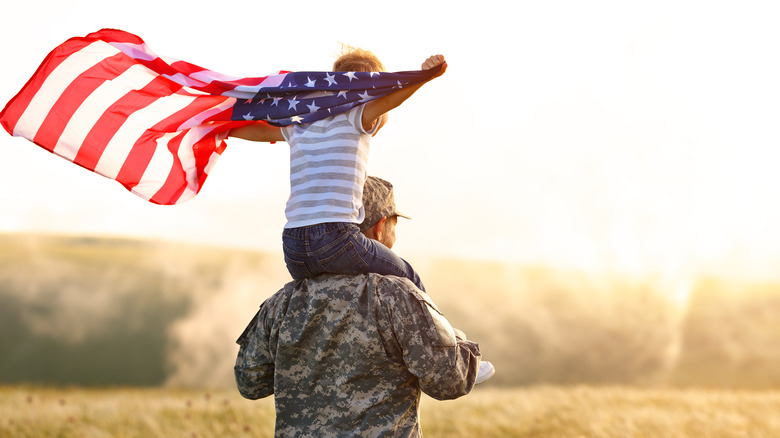 veteran with boy on shoulders