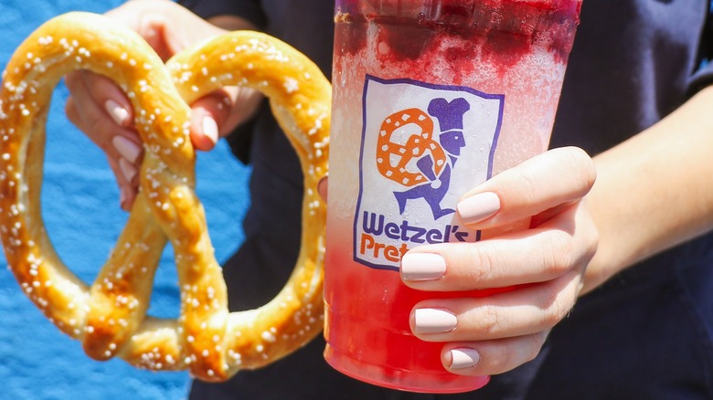 individual holding a Wetzel's boba and pretzel