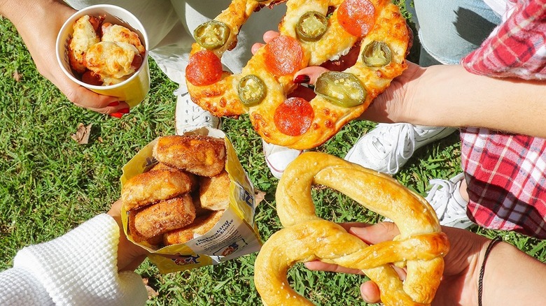 multiple people holding assorted Wetzel's items