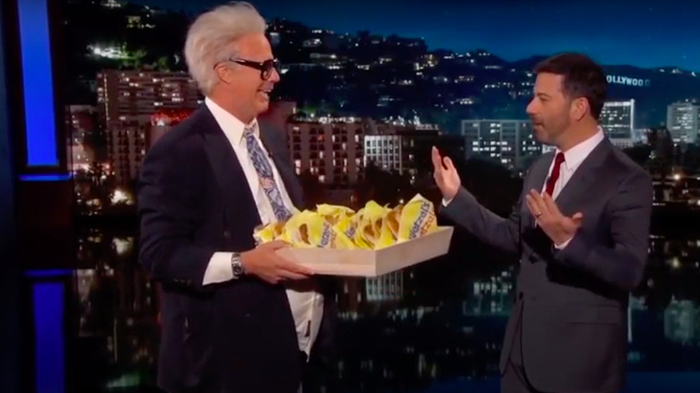 Will Ferrell offering wetzel's pretzels to Jimmy Kimmel