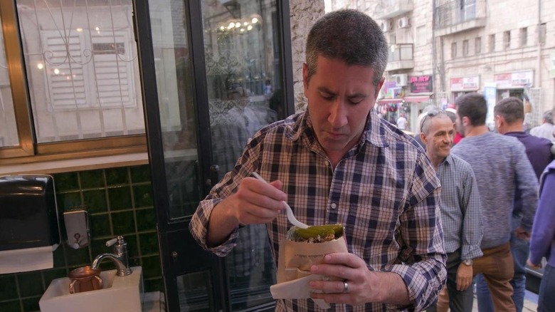 Mike Solomonov eating pensively