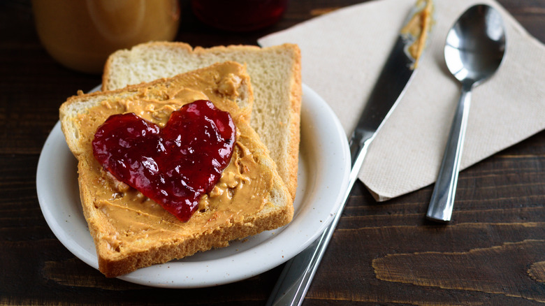 Peanut butter and jelly sandwich on a white plate