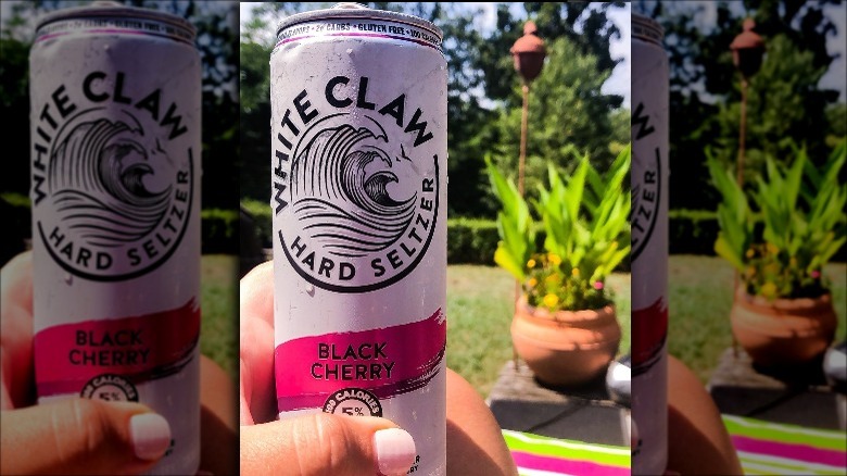 holding can of white claw 