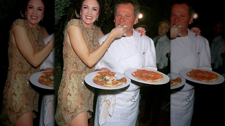 Barbara Lazaroff and Wolfgang Puck with pizzas