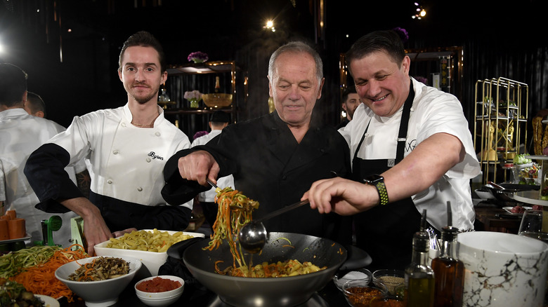 Wolfgang Puck cooking with other chefs