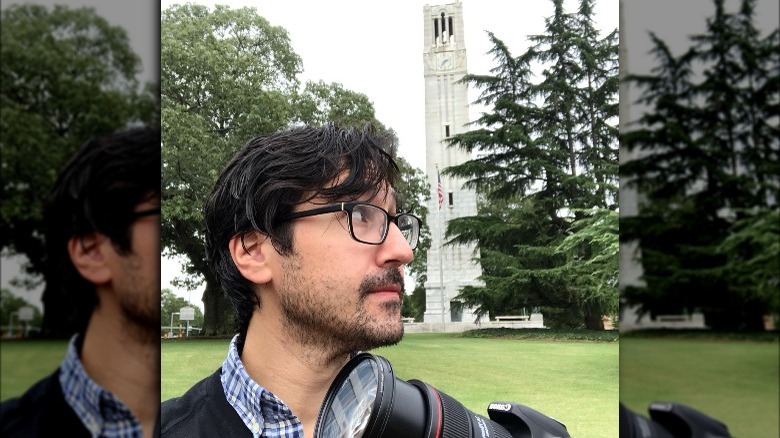 journalist adam ragusea with camera at college