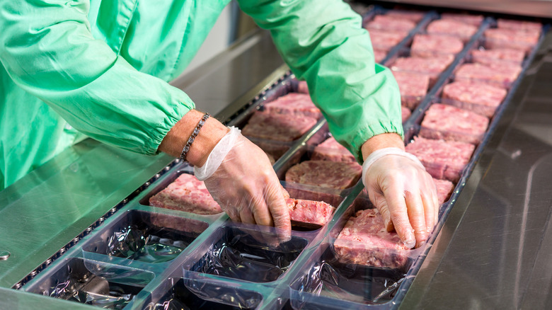 ground beef going through meat processing plant 