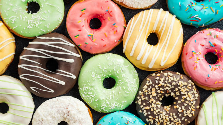 Array of colorful frosted donuts