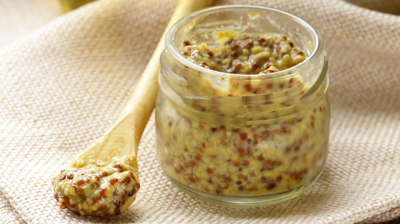 Dijon mustard in jar and on spoon