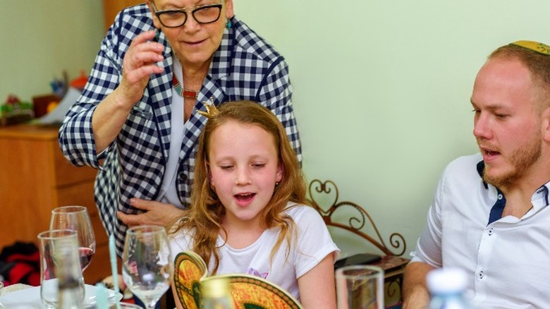 Three generations of Jewish family around Seder table