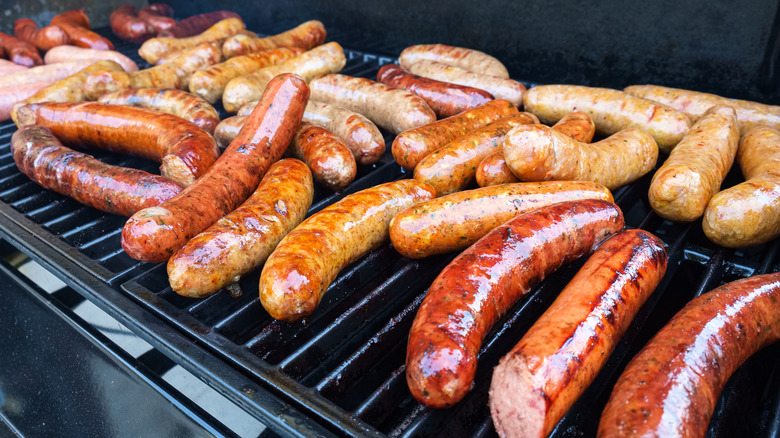 cooking bratwursts on grill