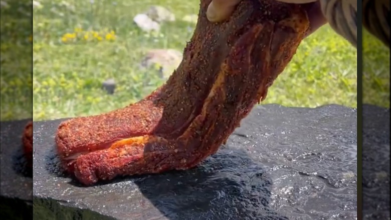 steak being cooked on a stone