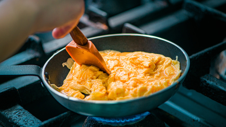 scrambled eggs cooking in pan