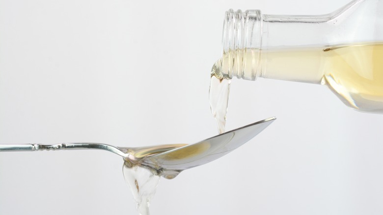 vinegar pouring into spoon