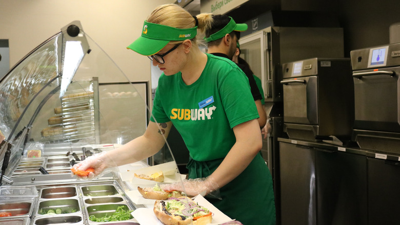 Subway employee making a sub