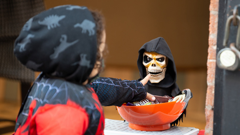 Child reaching for Halloween candy