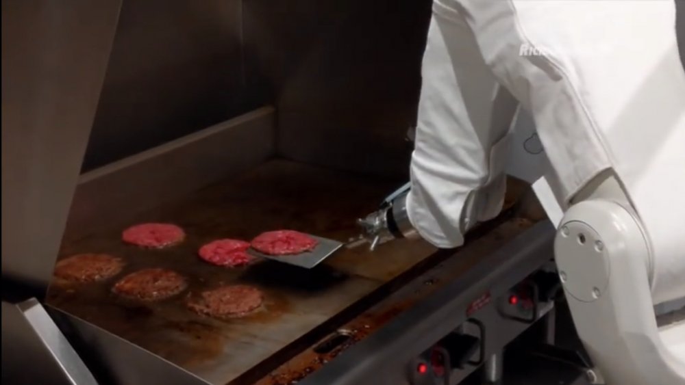 Flippy the robot cooking hamburger patties