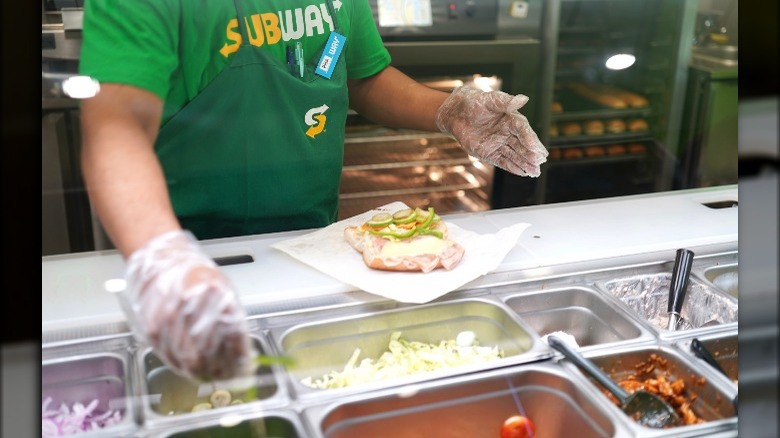 sandwich artist making a sandwich