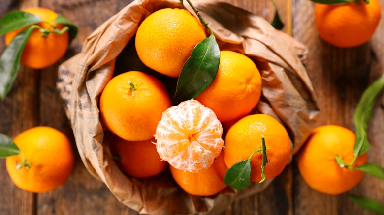 A burlap sack filled with clementines 