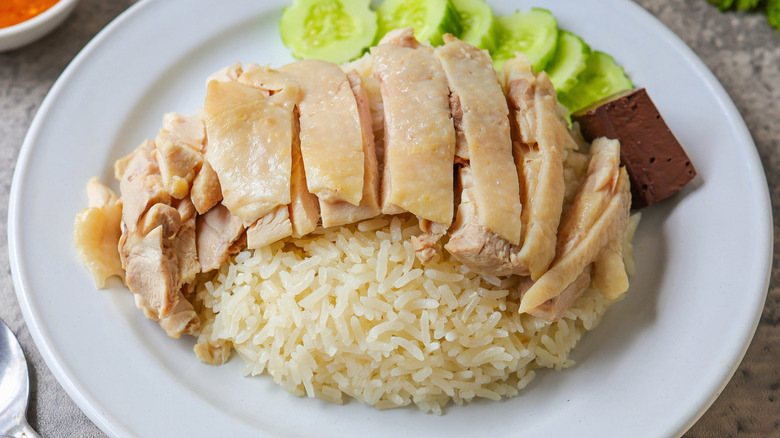 chicken, rice, and cucumbers on white plate