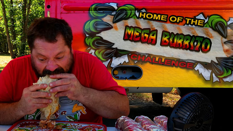 man eating a giant burrito