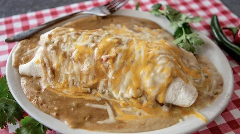 Giant breakfast burrito on plate