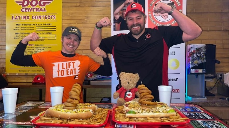 competitive eaters with hot dogs