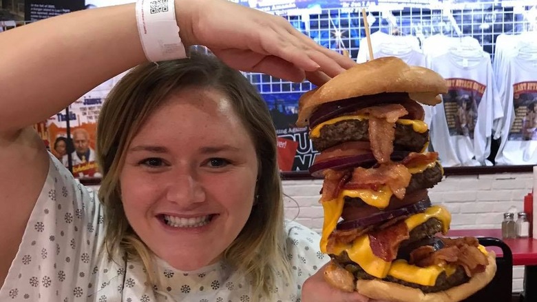 Woman holding a giant burger