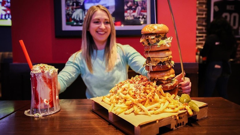 Woman posing with burger 