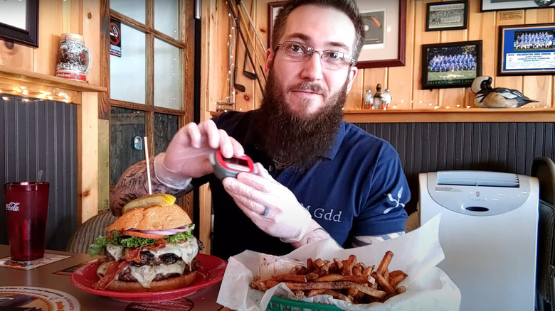 Man eating the Dozer burger