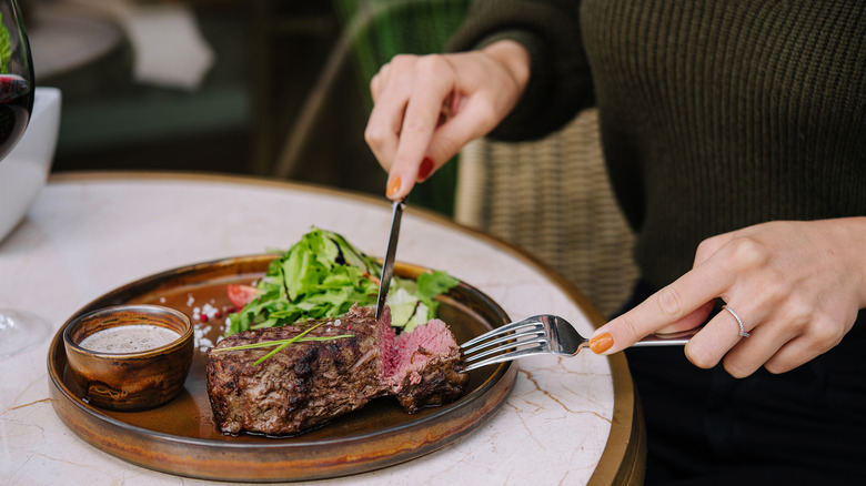 woman eating steak