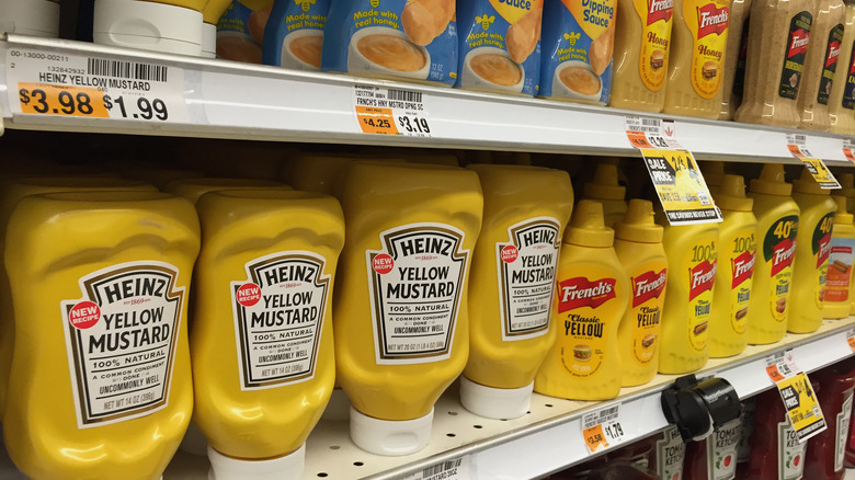 A lineup of mustards in a grocery store