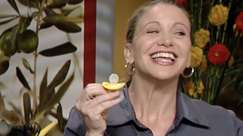 Michelle Bernstein smiles holding pacifier