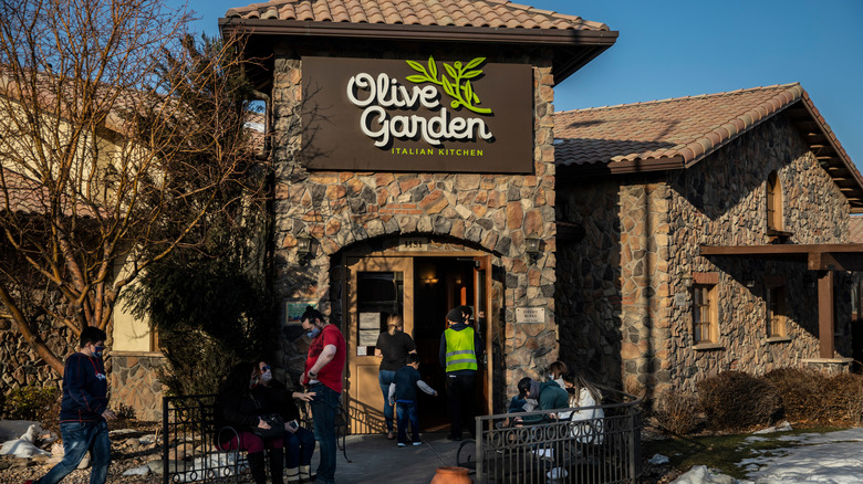 People walking outside Olive Garden restaurant