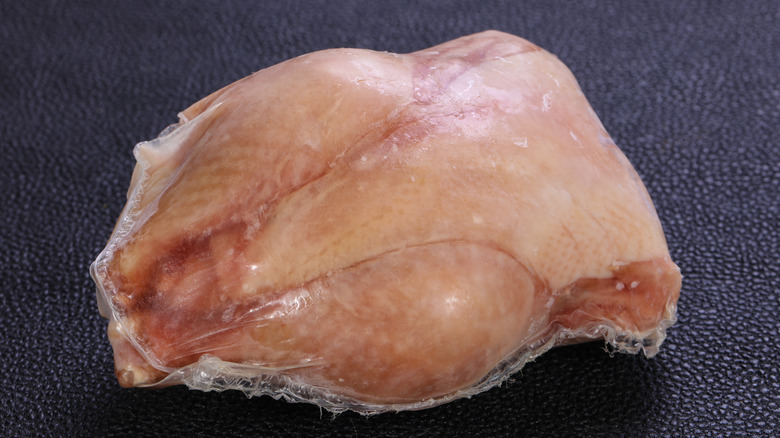 raw chicken wrapped in plastic